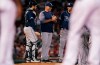 Tampa Bay Rays manager Kevin Cash smiles as he talks with his players during a pitching change in the seventh inning of the team's baseball game against the Boston Red Sox at Fenway Park in Boston, Wednesday, July 31, 2019. (AP Photo/Charles Krupa)