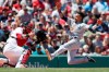 Seattle Mariners' J.P Crawford, right, scores on a double by Daniel Vogelbach as Boston Red Sox's Sandy Leon fields the throw during the first inning of a baseball game in Boston, Saturday, May 11, 2019. (AP Photo/Michael Dwyer)