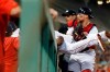 Boston Red Sox's Michael Chavis makes a catch on a pop foul by Los Angeles Dodgers' Enrique Hernandez over the dugout rail as Christian Vazquez, right, holds his legs during the fourth inning of a baseball game in Boston, Sunday, July 14, 2019. (AP Photo/Michael Dwyer)
