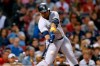 New York Yankees' Edwin Encarnacion hits an RBI double during the ninth inning of a baseball game against the Boston Red Sox in Boston, Saturday, Sept. 7, 2019. (AP Photo/Michael Dwyer)