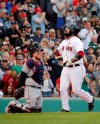 Boston Red Sox's Sandy Leon, right, points as he crosses home plate after hitting a three-run home run as Cleveland Indians catcher Roberto Perez (55) looks on during the fifth inning of a baseball game, Monday, May 27, 2019, in Boston. (AP Photo/Mary Schwalm)