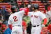 Boston Red Sox's Xander Bogaerts, left, welcomes home J.D. Martinez, right, after Martinez hit a homerun off a pitch by Seattle Mariners' Marco Gonzales during the first inning of a baseball game at Fenway Park, Sunday, May 12, 2019, in Boston. (AP Photo/Steven Senne)