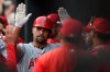 Los Angeles Angels' Albert Pujols is congratulated in the dugout after hitting a solo home run against the Baltimore Orioles in the fourth inning of a baseball game Saturday, May 11, 2019, in Baltimore. (AP Photo/Gail Burton)