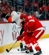 Philadelphia Flyers defenseman Andrew MacDonald (47) and Detroit Red Wings left wing Thomas Vanek (26) fight for the puck during the second period of an NHL hockey game, Sunday, Feb. 17, 2019, in Detroit. (AP Photo/Carlos Osorio)