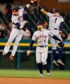 Houston Astros left fielder Josh Reddick (22), right fielder George Springer (4) and shortstop Carlos Correa (1) celebrate the team's 5-1 win over the Detroit Tigers in a baseball game, Wednesday, May 15, 2019, in Detroit. (AP Photo/Carlos Osorio)