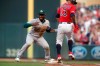 Minnesota Twins' Ehire Adrianza, right, is tagged out at first base by Oakland Athletics second baseman Jurickson Profar on Adrianza's sacrifice bunt during the third inning of a baseball game Thursday, July 18, 2019, in Minneapolis. (AP Photo/Jim Mone)
