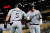 Chicago White Sox's Yolmer Sanchez, left, congratulates Zack Collins on his solo home run off Minnesota Twins pitcher Brusdar Graterol during the ninth inning of a baseball game Wednesday, Sept. 18, 2019, in Minneapolis. The White Sox won 3-1. (AP Photo/Jim Mone)