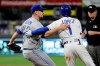 Toronto Blue Jays relief pitcher Daniel Hudson catches Kansas City Royals' Nicky Lopez (1) after tagging him out at first to end a baseball game Tuesday, July 30, 2019, in Kansas City, Mo. Toronto won 9-2. (AP Photo/Charlie Riedel)