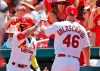 St. Louis Cardinals' Paul Goldschmidt, right, is congratulated by teammate Kolten Wong, left, after scoring during the first inning of a baseball game against the Arizona Diamondbacks Sunday, July 14, 2019, in St. Louis. (AP Photo/Jeff Roberson)