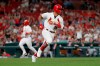 St. Louis Cardinals' Kolten Wong, right, runs to first as teammate Paul Goldschmidt comes in to score on Wong's two-run single during the seventh inning of a baseball game against the Milwaukee Brewers on Tuesday, Aug. 20, 2019, in St. Louis. (AP Photo/Jeff Roberson)