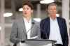 Manitoba Premier Brian Pallister listens as Prime Minister Justin Trudeau speaks during a press conference at a new 700-employee Canada Goose manufacturing facility in Winnipeg. (John Woods / The Canadian Press)