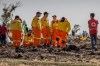 Investigators from Israel examine wreckage at the scene where the Ethiopian Airlines Boeing 737 Max 8 crashed shortly after takeoff on Sunday killing all 157 on board, near Bishoftu, or Debre Zeit, south of Addis Ababa, in Ethiopia Tuesday, March 12, 2019. Ethiopian Airlines had issued no new updates on the crash as of late afternoon Tuesday as families around the world waited for answers, while a global team of investigators began picking through the rural crash site. (AP Photo/Mulugeta Ayene)