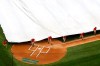 Grounds crew members pull a tarp over the infield during a rain delay before a baseball game between the Philadelphia Phillies and the Washington Nationals, Monday, June 17, 2019, in Washington. (AP Photo/Patrick Semansky)