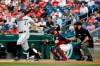Chicago White Sox's James McCann, left, singles in front of Washington Nationals catcher Yan Gomes and umpire Mike Everitt in the first inning of an interleague baseball game, Tuesday, June 4, 2019, in Washington. Yoan Moncada scored on the play. (AP Photo/Patrick Semansky)