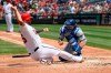 Washington Nationals' Matt Adams, left, is out at the plate against Los Angeles Dodgers catcher Will Smith during the second inning of a baseball game, Sunday, July 28, 2019, in Washington. (AP Photo/Nick Wass)