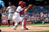 Miami Marlins' Starlin Castro, left, comes in to score on sacrifice fly by Miguel Rojas during the eighth inning of a baseball game against Washington Nationals catcher Kurt Suzuki, right, Monday, May 27, 2019, in Washington. (AP Photo/Nick Wass)