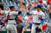 New York Mets catcher Wilson Ramos, left, and relief pitcher Justin Wilson high-five after closing out a baseball game against the Washington Nationals, Wednesday, Sept. 4, 2019, in Washington. New York won 8-4. (AP Photo/Patrick Semansky)