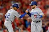 Los Angeles Dodgers first baseman Max Muncy celebrates his solo home run off Washington Nationals starting pitcher Anibal Sanchez with third base coach Dino Ebel (12) during the fifth inning in Game 3 of a baseball National League Division Series on Sunday, Oct. 6, 2019, in Washington. (AP Photo/Julio Cortez)