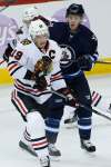 John Woods / The Canadian Press
Blackhawks captain Jonathan Toews grimaces during an encounter with Jets defender Toby Enstrom Tuesday night at the MTS Centre.