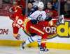 Jeff McIntosh / THE CANADIAN PRESS
Winnipeg Jets' Adam Lowry, right, knocks Calgary Flames' Deryk Engelland to the ice during first period NHL hockey action in Calgary, Saturday.