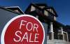 Sean Kilpatrick
/ The Canadian Press
A sign advertises a new home for sale in Carleton Place, Ont., on March 17, 2015. The head of the federal housing agency is raising a red flag about the state of Canada’s real estate sector, saying affordability concerns have spilled over from the country’s two most expensive cities to nearby markets.