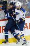 JOHN WOODS / THE CANADIAN PRESS FILES
St. Louis Blues' Joel Edmundson checks Winnipeg Jets' Andrew Copp during third period NHL action in Winnipeg.