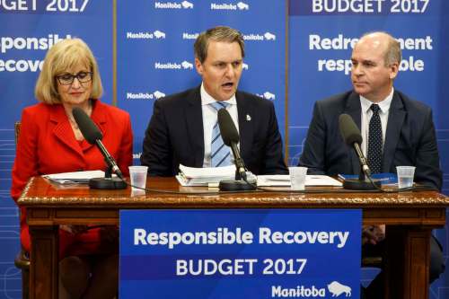 Manitoba Finance Minister Cameron Friesen, flanked by Janice McKinnon (left) and Dave Angus (right) who are co-chairs of the advisory panel on fiscal performance, during his presentation of the 2017-2018 budget to the media. (Mike Deal / Winnipeg Free Press)