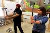 BORIS MINKEVICH / WINNIPEG FREE PRESS
Jen Zoratti tries throwing an axe and gets a lesson in the pastime from Dan Blair at Bad Axe Throwing.