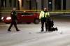 Police investigate the fatal hit-and-run on Main Street at Sutherland Avenue. (John Woods / Winnipeg Free Press)