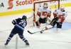 THE CANADIAN PRESS/Trevor Hagan
Winnipeg Jets' Patrik Laine fires a shot at Calgary Flames goaltender Eddie Lack with Michael Stone in front of the net.