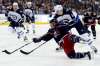 Paul Vernon / The Associated Press
Columbus Blue Jackets forward Cam Atkinson (13) shoots the puck against Winnipeg Jets defenseman Tyler Myers (57) during the second period of an NHL hockey game in Columbus, Ohio, Friday, Oct. 27, 2017.