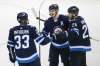 Winnipeg Jets defenceman Dustin Byfuglien (33) centre Mark Scheifele (55) and right wing Blake Wheeler (26) celebrate Scheifele's goal against the Pittsburgh Penguins during third period NHL action in Winnipeg on Sunday, October 29, 2017. THE CANADIAN PRESS/John Woods