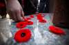 People place their poppies during a Remembrance Day ceremony at Vimy Ridge Memorial Park in Winnipeg in 2016. (John Woods / The Canadian Press files)