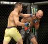 TREVOR HAGAN / WINNIPEG FREE PRESS
Rafael dos Anjos slugs Robbie Lawler during their welterweight bout on Saturday night.