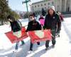 A couple of dozen marchers, including Serena McKay's mother, Delores Daniels (centre), marched from the Legislature Saturday. (Phil Hossack / Winnipeg Free Press)