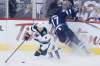 Mikko Koivu battles Adam Lowry for a loose puck last Friday. (John Woods / Canadian Press files)