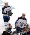 (AP Photo/Andy Clayton-King)
Winnipeg Jets players Jack Roslovic, left, and Brandon Tanev skate off the ice after losing to the Minnesota Wild, Sunday.