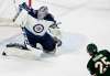 Carlos Gonzalez / Minneapolis Star Tribune
Winnipeg Jets goalie Connor Hellebuyck makes a big save in the second period in front of the Minnesota Wild&rsquo;s Jonas Brodin during Game 4 of their NHL playoff series in Minnesota.