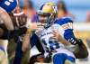 THE CANADIAN PRESS/Darryl Dyck
Winnipeg Blue Bombers quarterback Alex Ross (18) fumbles the ball while being tackled by B.C. Lions' Davon Coleman, back, during the first half of a pre-season CFL football game in Vancouver, on Friday June 8, 2018. B.C. Lions' Odell Willis recovered the ball and ran it in for a touchdown.