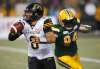 Jason Franson / The Canadian Press
Ticats quarterback Jeremiah Masoli gets away from the Eskimos&rsquo; Jake Ceresna on June 22.