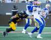 Winnipeg Blue Bombers quarterback Chris Streveler is stalked by Hamilton Tiger-Cats defensive end Julian Howsare during the first quarter. (Peter Power / The Canadian Press)