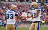 Winnipeg Blue Bombers' Andrew Harris celebrates his touchdown with teammate Adarius Bowman during the game against the Toronto Argonauts, in Toronto on Saturday. (Mark Blinch / The Canadian Press)