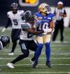 PHIL HOSSACK / WINNIPEG FREE PRESS
Winnipeg Blue Bombers' Nic Demski works around Toronto Argonauts' Cassius Vaughn Friday evening at Investors Group Field.