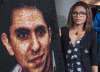 Ensaf Haidar stands next to a poster of a book of articles written by the imprisoned Saudi blogger and Haidar's husband, Raif Badawi, on June 16, 2015 in Montreal. Saudi Arabia is retaliating after Global Affairs Canada tweeted its concern about the arrests of civil society and women's rights activists in Saudi Arabia, including jailed blogger Badawi and his sister Samar Badawi. (Paul Chiasson / The Canadian Press Files)