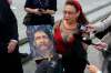 BORIS MINKEVICH / WINNIPEG FREE PRESS files
Esther Grant holds a painting by artist Gord Hagman of Brian Sinclair outside of the Winnipeg courthouse in 2013.