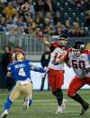 THE CANADIAN PRESS/John Woods
Calgary Stampeders quarterback Bo Levi Mitchell throws under pressure from a blitzing Adam Bighill during the first half in Winnipeg, Friday.