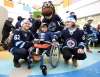 RUTH BONNEVILLE / WINNIPEG FREE PRESS
The Winnipeg Jets Hockey Club make their annual holiday hospital visit to the Children's Rehab Centre Thursday. N'tanis George, age 11, has her picture taken with Winnipeg Jets Players, Nelson Nogier, left, and Sami Niku Thursday.