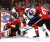 Goaltender Anders Nilsson (31) smothers the puck as Andrew Copp and Brendan Lemieux dig for a loose puck in the second period. (Fred Chartrand / The Canadian Press)
