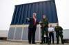 Evan Vucci / The Associated Press FILES
U.S. President Donald Trump talks with reporters in 2018 as he reviews border wall prototypes in San Diego.