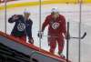 New Jets Matt Hendricks (left) and Nathan Beaulieu get aquainted with their new teammates on the ice Tuesday morning. (Mike Deal / Winnipeg Free Press)